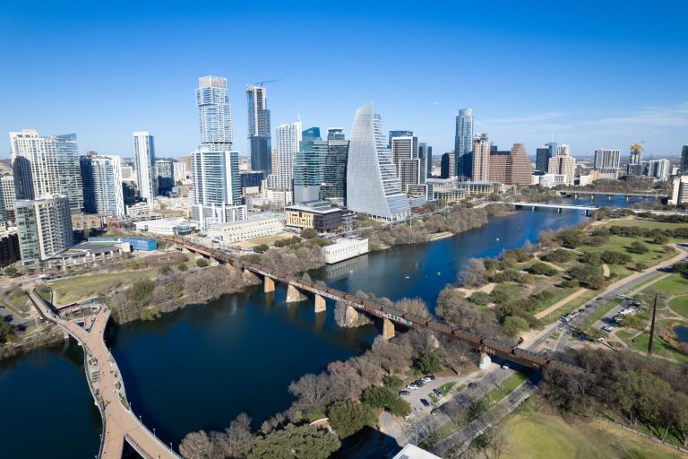 Ship-n-Crate residential moving and crating services with Lady Bird Lake and Austin skyline in the background.